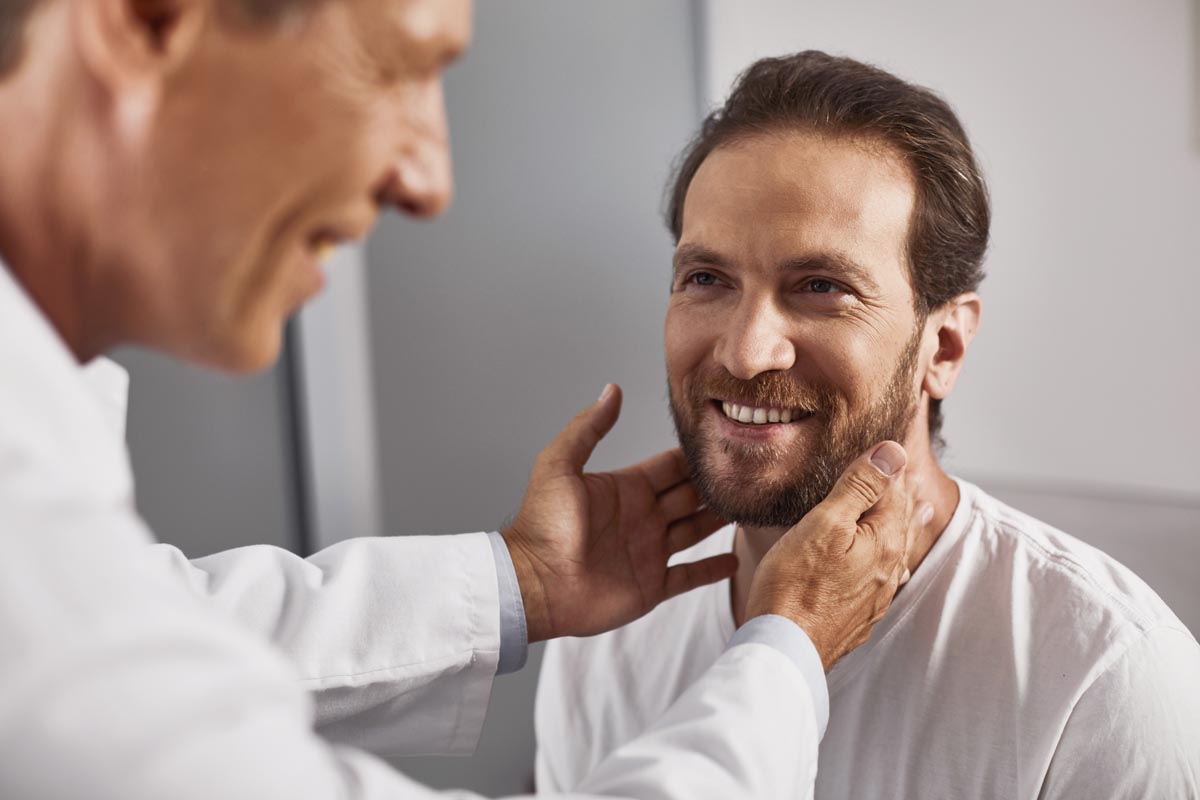 Patient receiving examination of lymph nodes in doctor office.