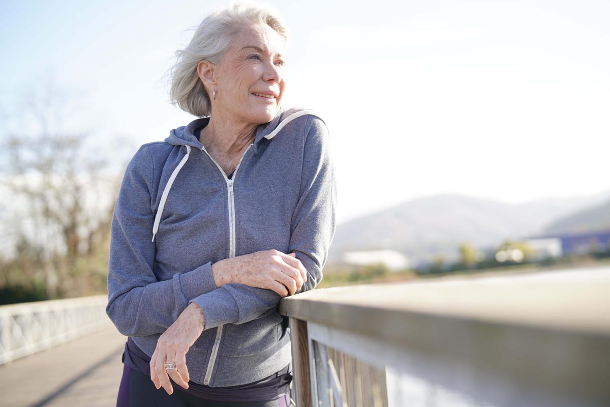 Portrait of attractive senior woman in sportswear outdoors.